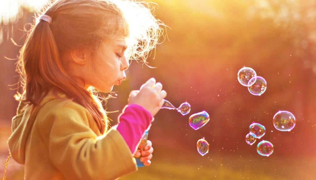 stock photo of child blowing bubbles
