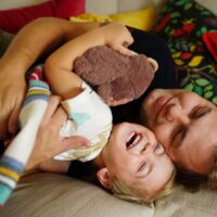 A,Joyful,Father,And,Young,Son,Cuddling,Together,On,A