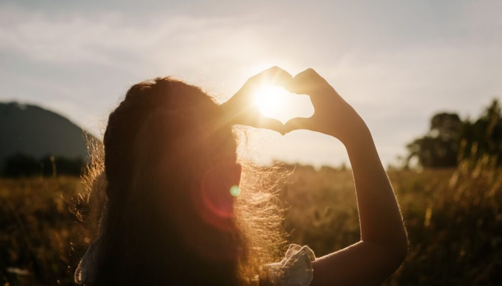 Back,View,Of,Little,Girl,Child,Making,Heart,With,Hands