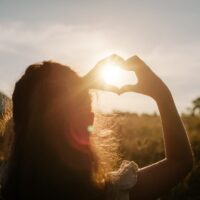 Back,View,Of,Little,Girl,Child,Making,Heart,With,Hands
