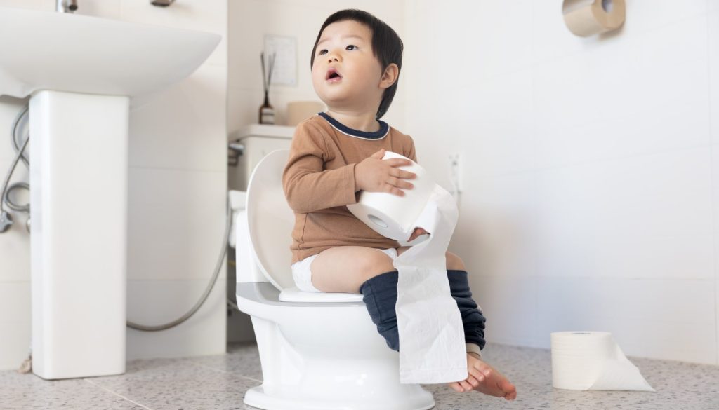 A,Child,Being,Potty,Trained,On,A,Children's,Toilet,In